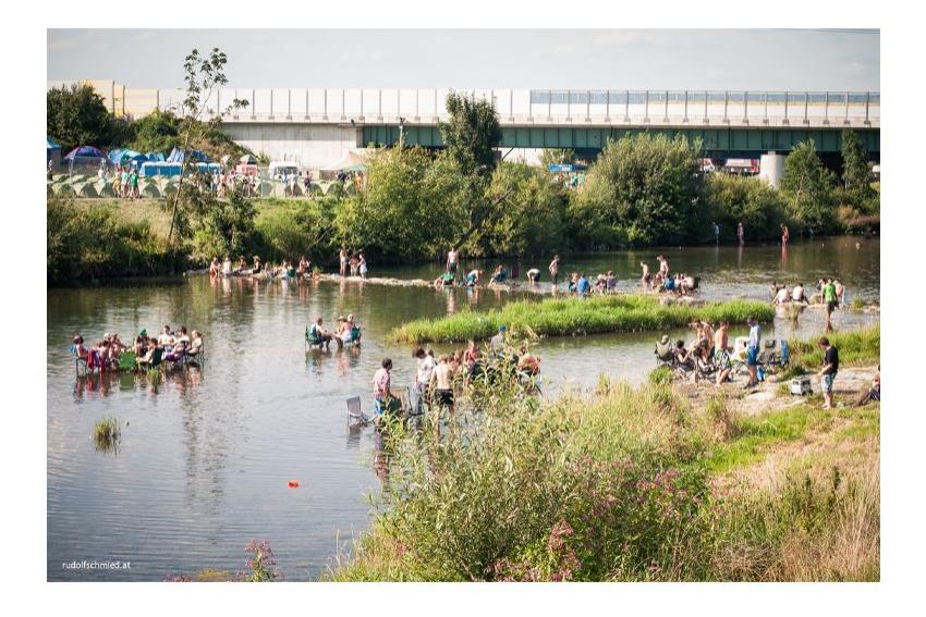 Musikfans beim Abkühlen iin einem Fluss